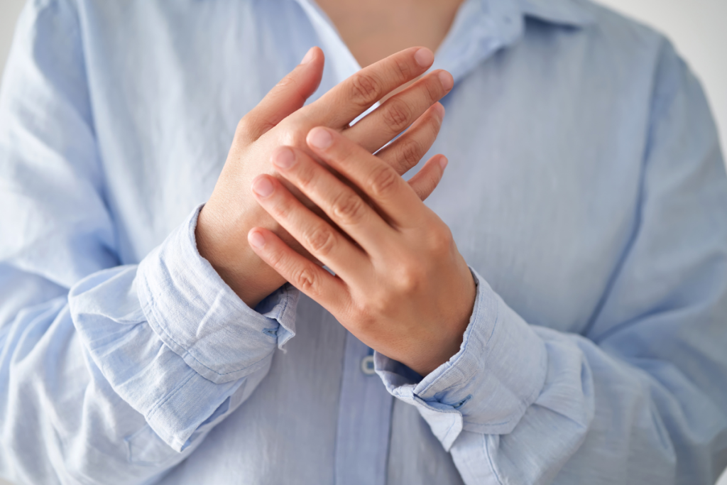 A woman withn numb hands rubbing her fingers together in Ohio.