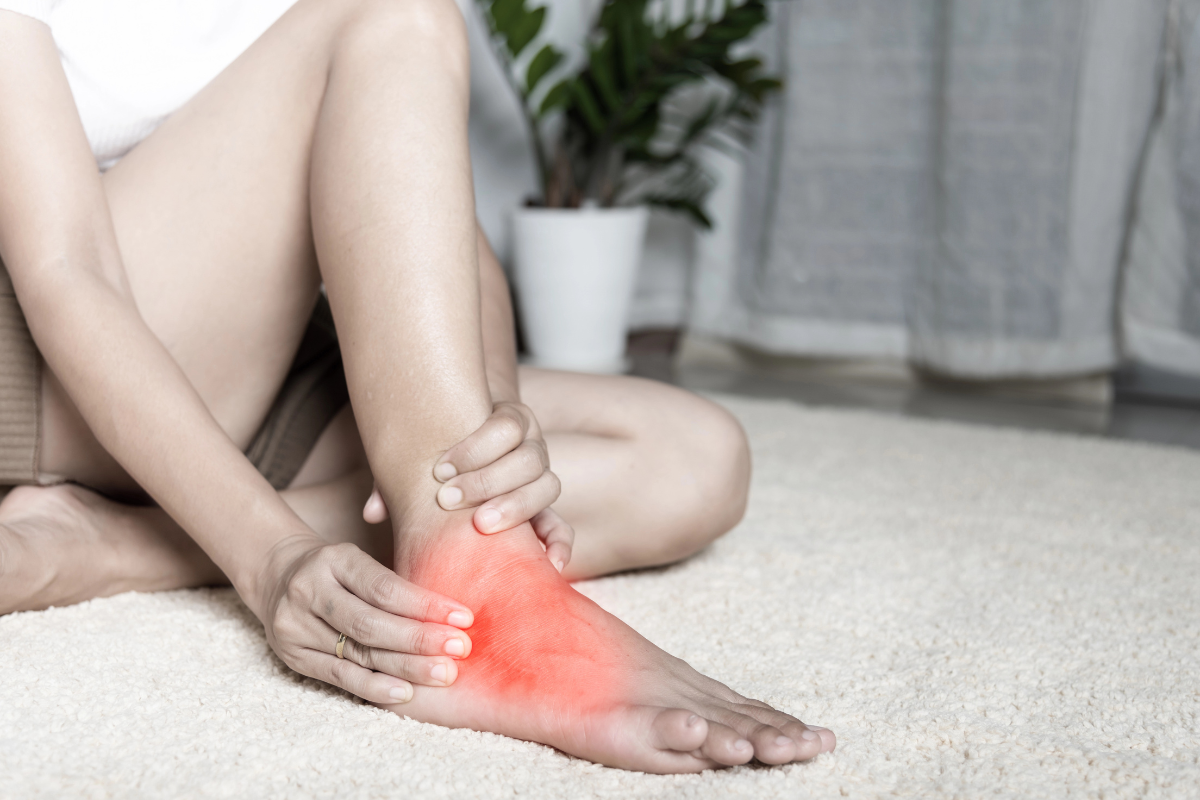 A woman holding the top of her foot in pain in Chardon, Ohio.